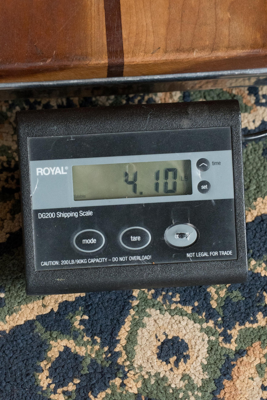 A digital shipping scale shows 4.10 lbs—ideal for the *New 2025 Model* Martin OOOE Retro Plus Torrefied Spruce/Mahogany OOO Guitar w/Martin Electronics #8194 by Martin & Co. Scale includes mode, tare, set buttons, and a 200 lb/90 kg capacity warning.