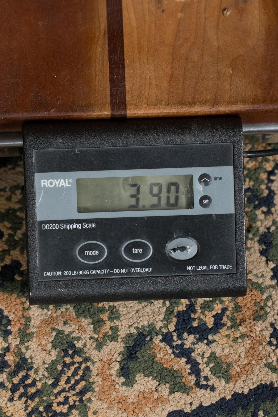 Digital scale displaying 3.90 pounds on a dark wood surface above patterned carpet. - Martin OOO Jr CE Spruce/Sapele OOO Cutaway Guitar w/Martin Electronics #4756 - Default Title