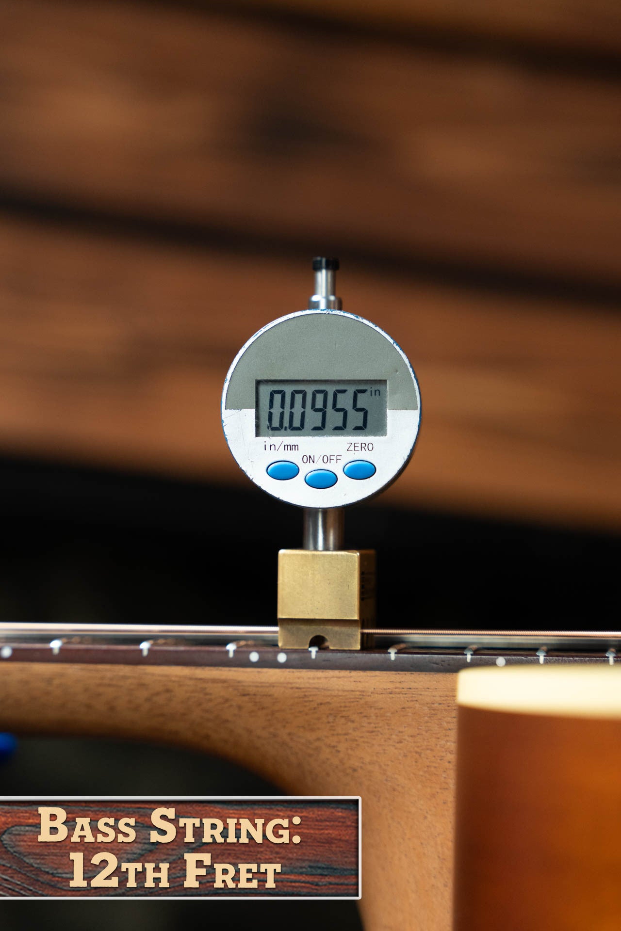 A digital caliper measures 0.0955 inches above the 12th fret of a bass guitar—precision akin to that found in the Maton Guitars T.E. Personal Spruce/Queensland Maple Deep Body OO Guitar w/Electronics #0085. Text in image: Bass String: 12th Fret.
