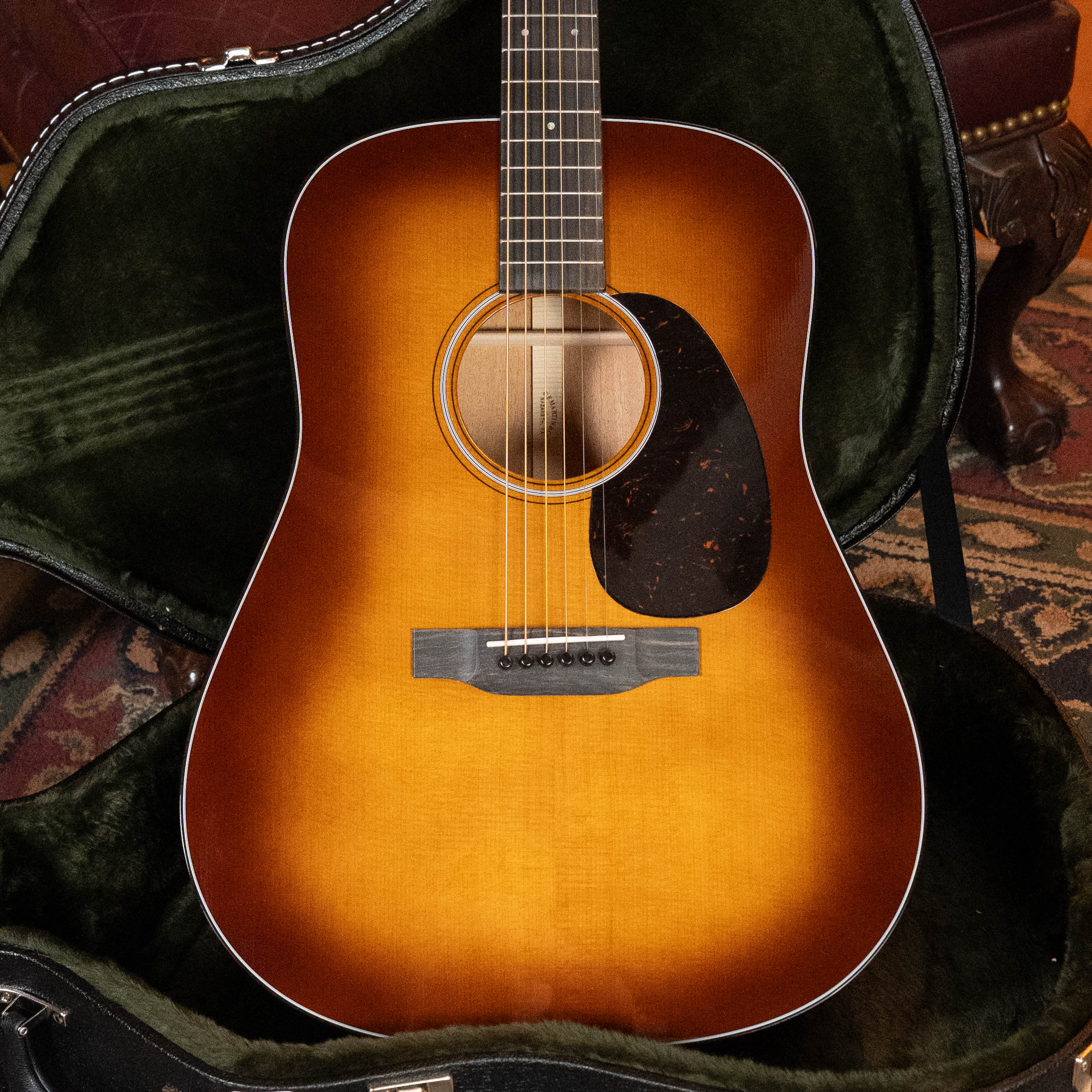 The *New 2025 Model* Martin & Co. D-18 1933 Gloss Ambertone Spruce/Mahogany Dreadnought Acoustic Guitar #6784, with a tortoiseshell pickguard, rests in an open plush-lined hard case on a patterned rug.