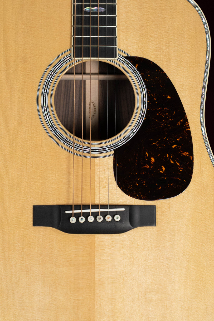 Close-up of the Martin & Co. D-41 Spruce/Indian Rosewood Dreadnought Acoustic Guitar #5217 body, featuring the sound hole, strings, pickguard, and bridge on a light spruce top with Indian rosewood back and sides.