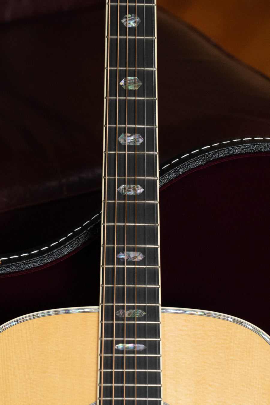 A close-up of a Martin & Co. D-41 Spruce/Indian Rosewood Dreadnought Acoustic Guitar #5217’s neck, showing decorative inlays, detailed binding, and a light spruce top contrasted against dark Indian rosewood accents.