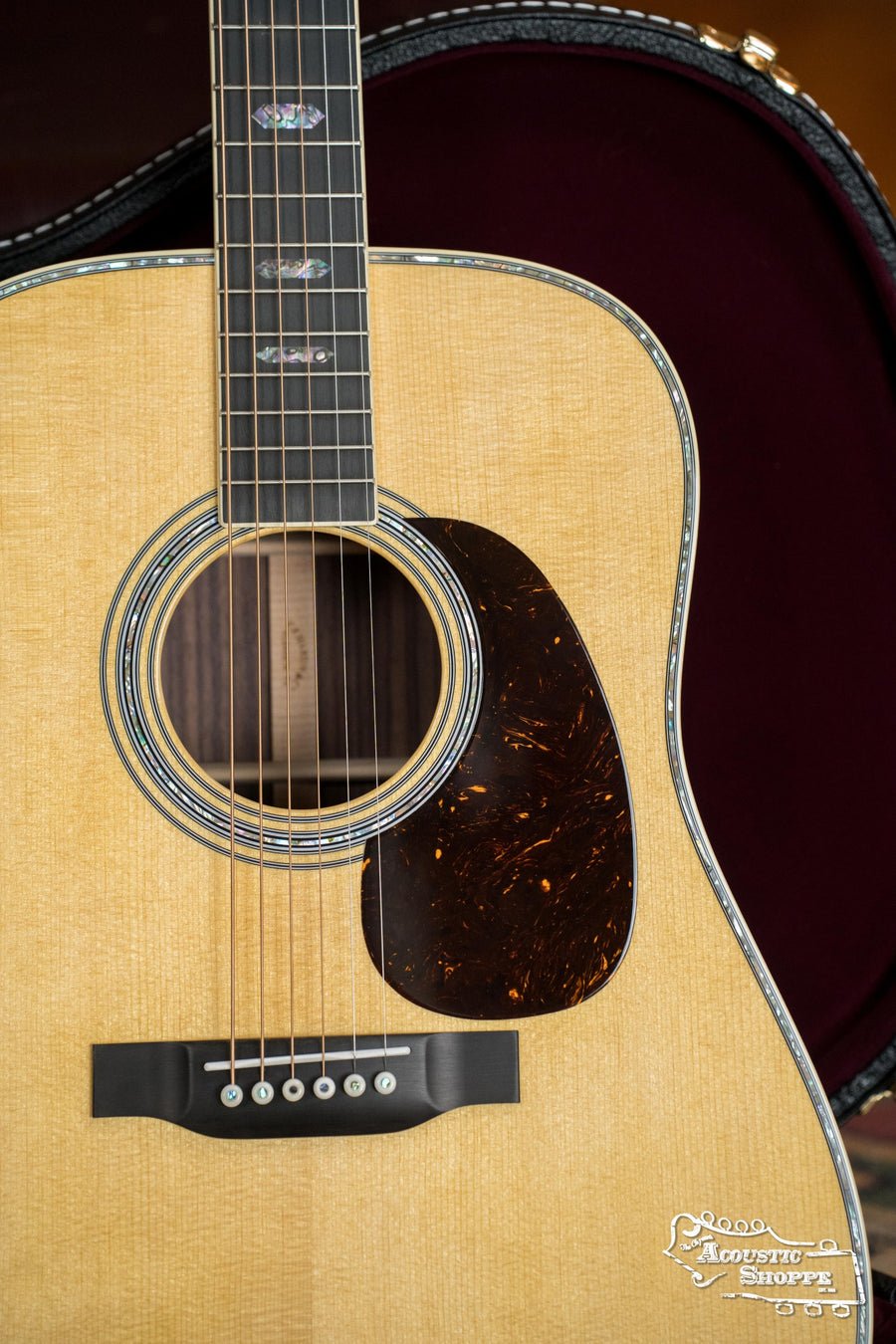 A close-up of the *New 2025 Model* Martin & Co. D-41 Spruce/Indian Rosewood Dreadnought Acoustic Guitar #1388, highlighting its spruce top, Indian rosewood back and sides, tortoiseshell pickguard, inlaid fretboard, and hard case in the background.