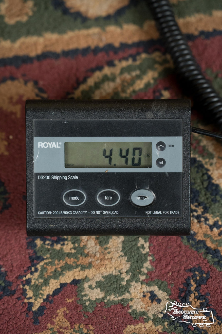 A digital shipping scale shows the *New 2025 Model* Martin & Co. D-41 Spruce/Indian Rosewood Dreadnought Acoustic Guitar #1388 weighs 4.40 lb. The ROYAL scale has mode, tare, and on/off buttons and sits on patterned carpet.