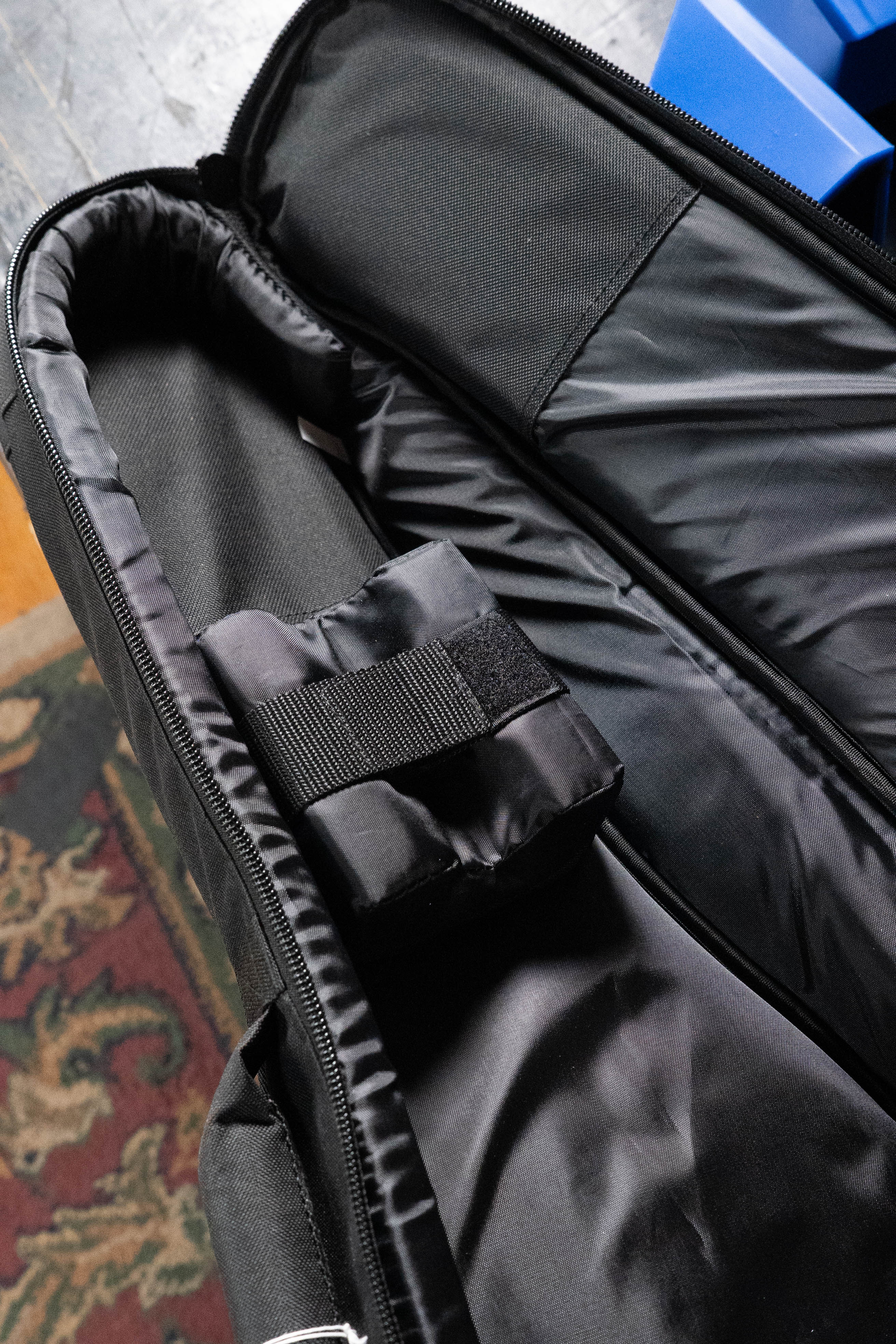 The Ortega ONB-MA Standard Size Mandolin Bag in brown with black, crafted from heavy-duty nylon, offers safe transport for your instrument or equipment. It features a padded interior and Velcro strap for security, perfect for musicians on the go.