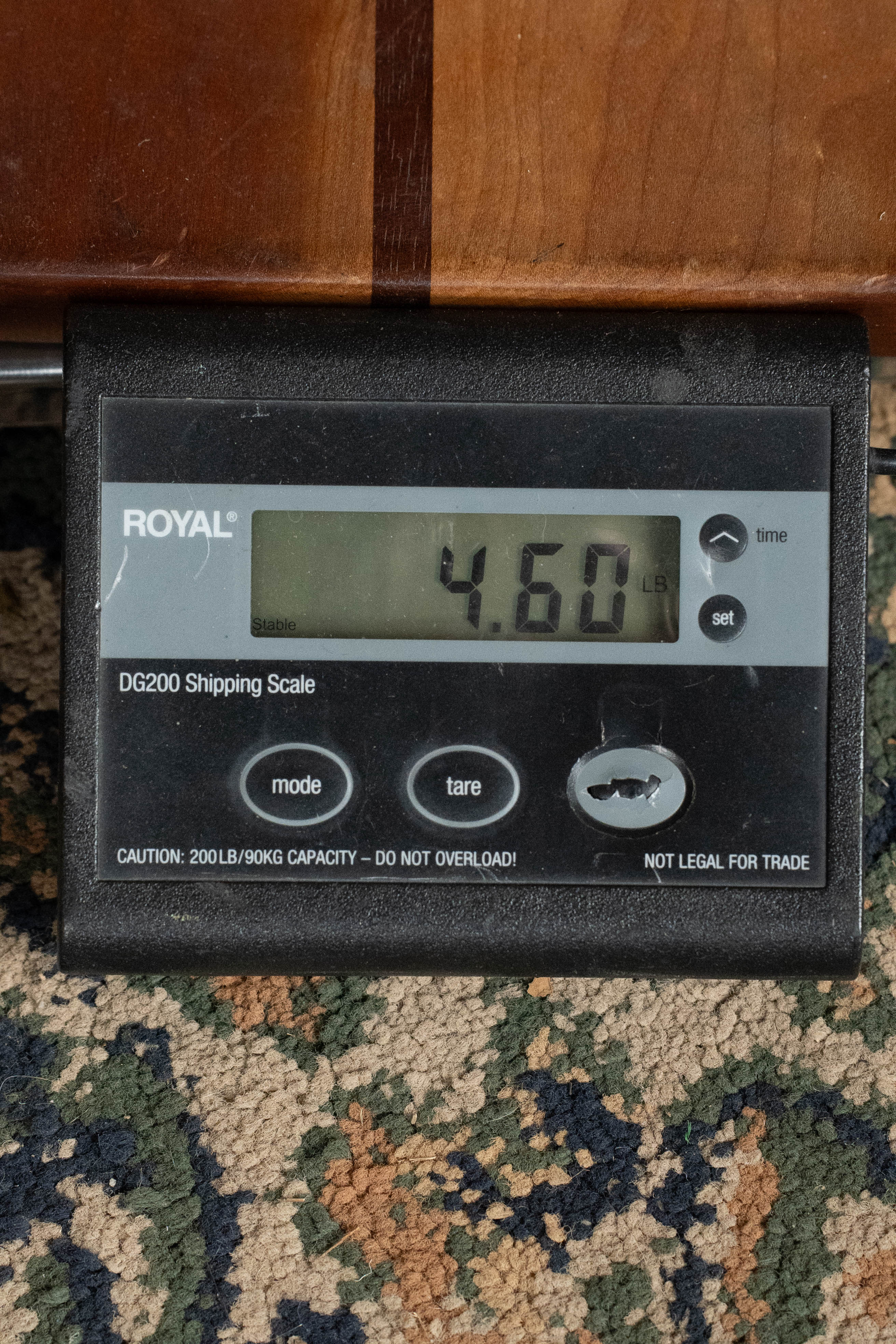 A digital shipping scale shows 4.60 pounds. The black scale is on patterned carpet, with a *Pre-Order 25% Deposit ONLY* Bourgeois TAS LSH Professional Series Satin Dreadnought Guitar by Bourgeois partly visible above it.