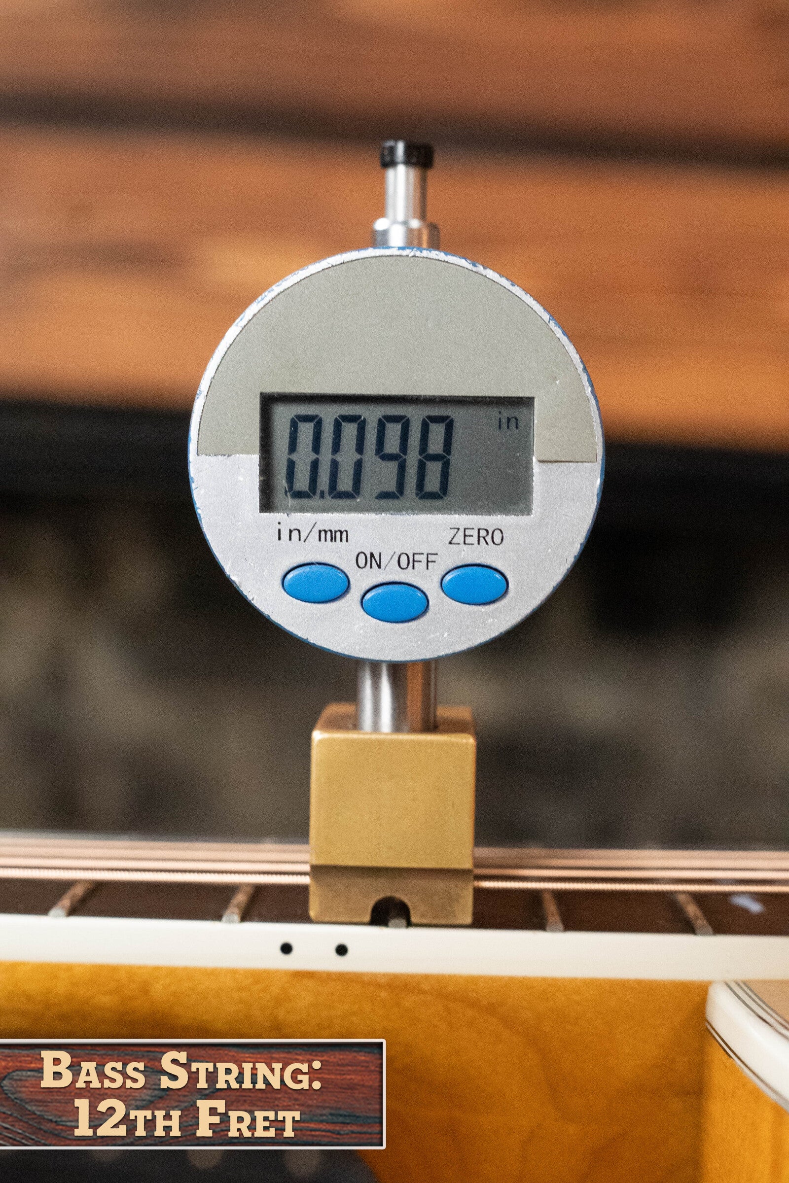 A digital gauge shows 0.098 inches measuring the bass string height above the 12th fret on a (Used) 2009 Taylor 614CE Torrefied Sitka/Maple Grand Auditorium Guitar w/Pickup #5110 by Taylor Guitars. Label: Bass String: 12th Fret.