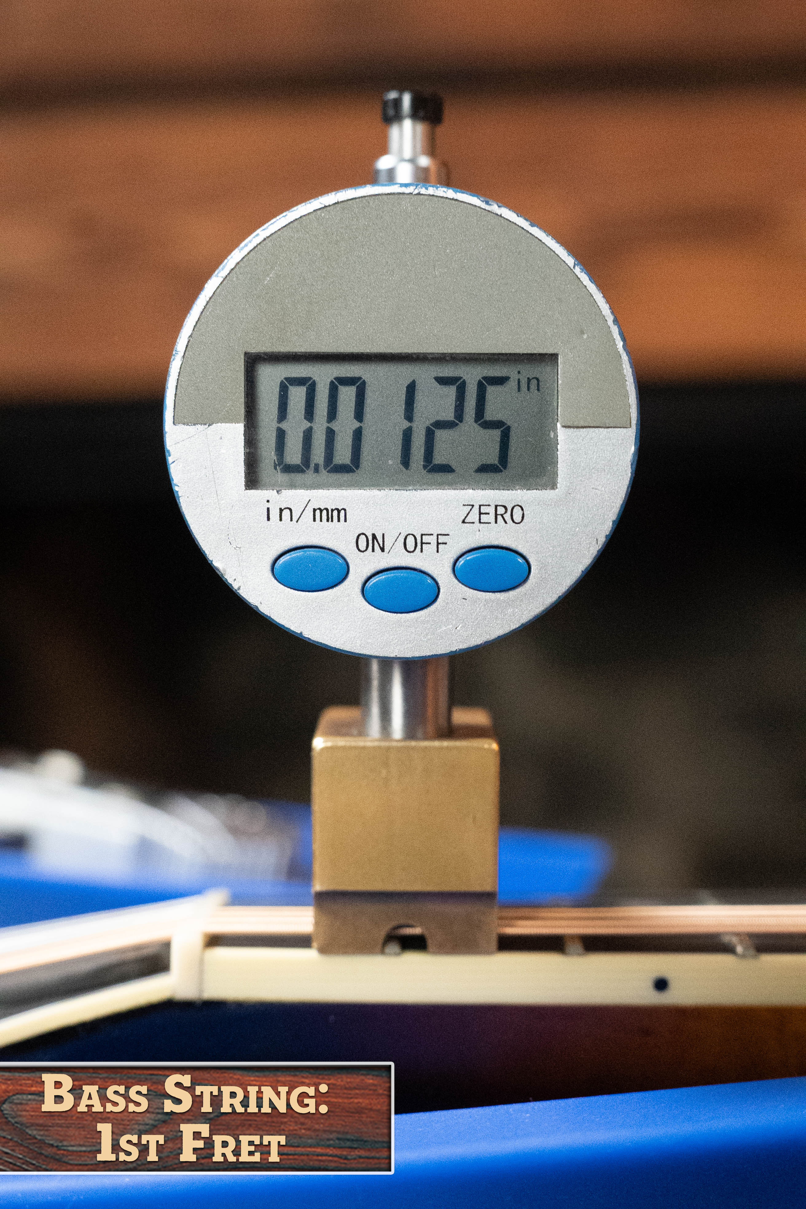 A digital gauge displays 0.0125 inches, measuring string height at the 1st fret of a (Used) 2016 Weber Fern Red Spruce/Flamed Maple A-Style Mandolin #2801, similar to checking action on an A-style by Weber. "Bass String: 1st Fret" appears in the corner.