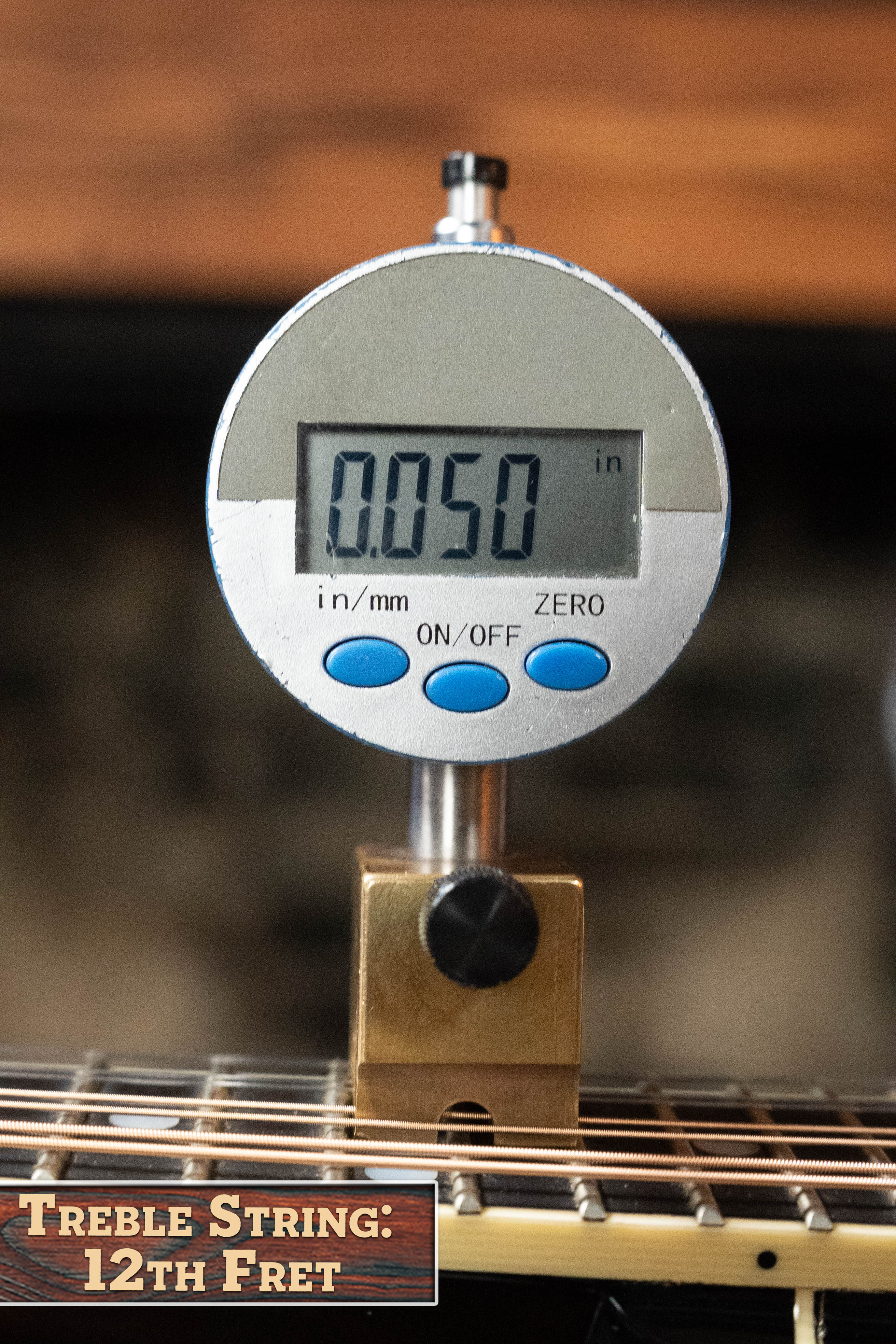 A digital gauge shows 0.050 inches above the fret; a bottom left overlay reads, Treble String: 12th Fret, showcasing precise setup for the (Used) 2016 Weber Fern Red Spruce/Flamed Maple A-Style Mandolin #2801 by Weber.