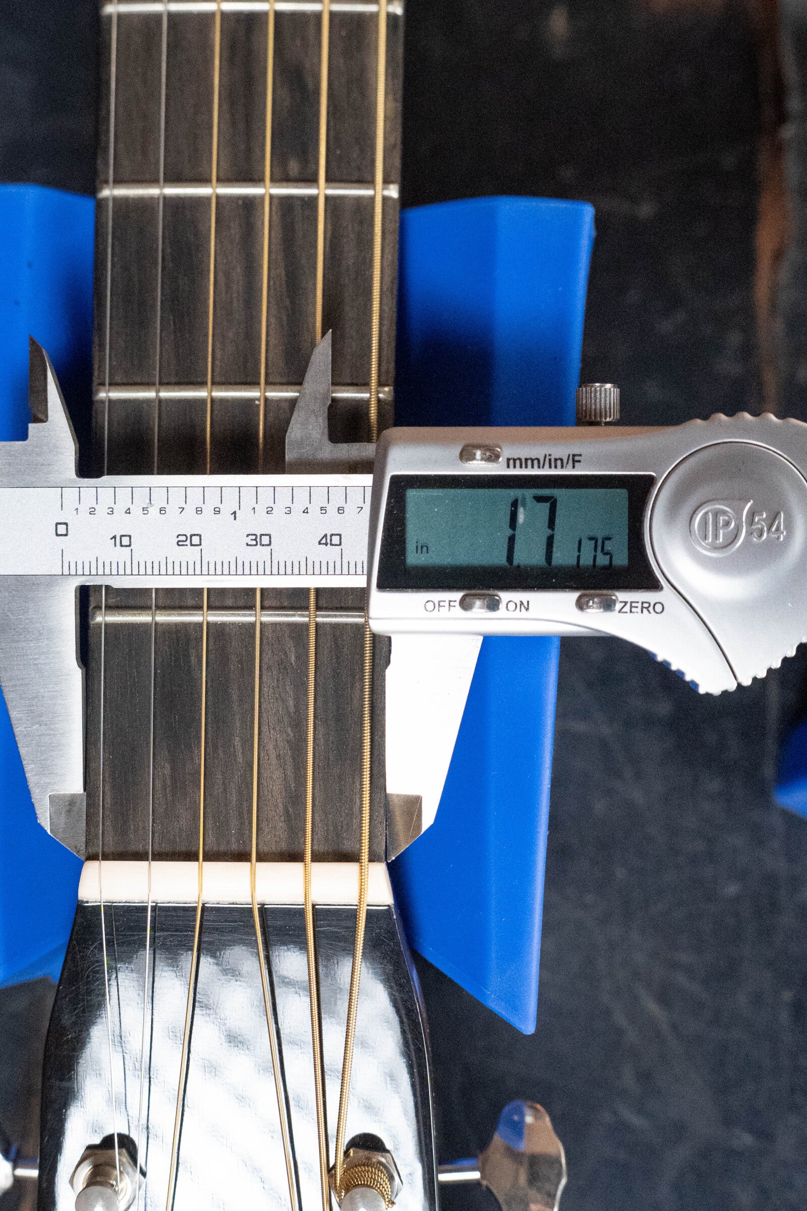 A digital caliper measures the nut width of a (Used) 2022 Martin Brook Ligertwood 000-28 Spruce/Rosewood OOO Acoustic Guitar by Martin & Co., showing 1.775 inches across the East Indian rosewood fretboard at the first fret.