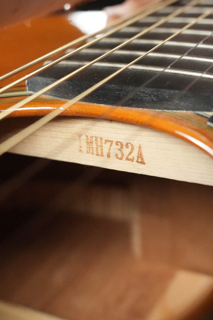 Close-up of a Yamaha FG5 GL NEW Gloss Red Label Dreadnought Acoustic Guitar #732A, highlighting its solid spruce top, strings, fretboard, and the #732A code visible on a wooden brace inside the body.