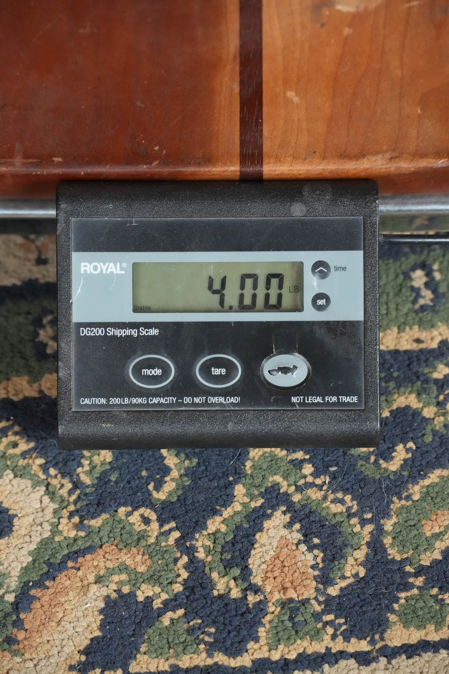 A digital shipping scale on a patterned carpet reads 4.00 pounds with the Yamaha FG5 GL NEW Gloss Spruce/Mahogany Red Label Dreadnought Acoustic Guitar #520A resting atop, and the Royal DG200 brand displayed.