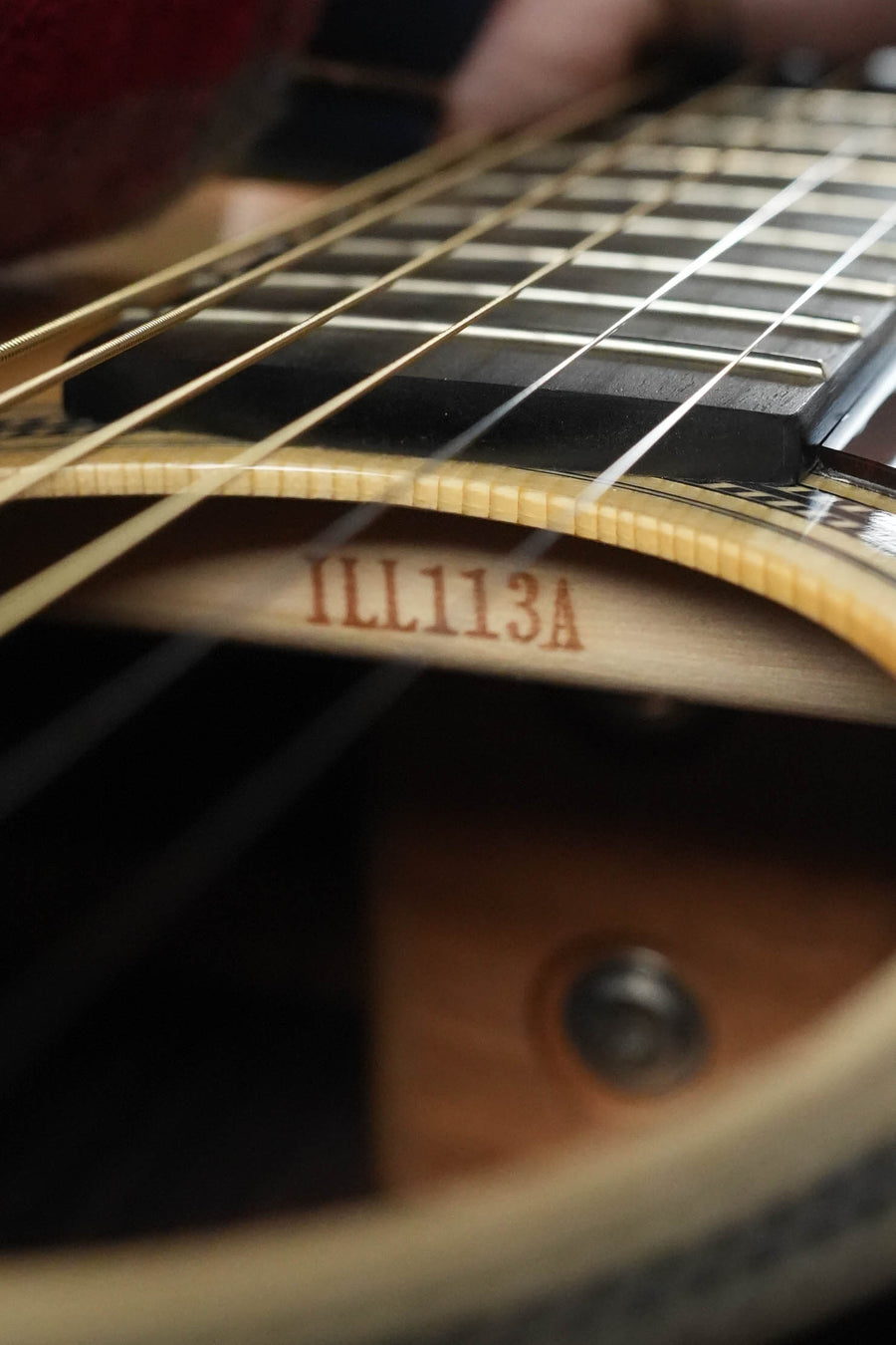 Close-up of a Yamaha FG9 R NT Adirondack/Indian Rosewood Dreadnought Acoustic Guitar #113A, highlighting the strings, fretboard, and the #113A label inside the body.