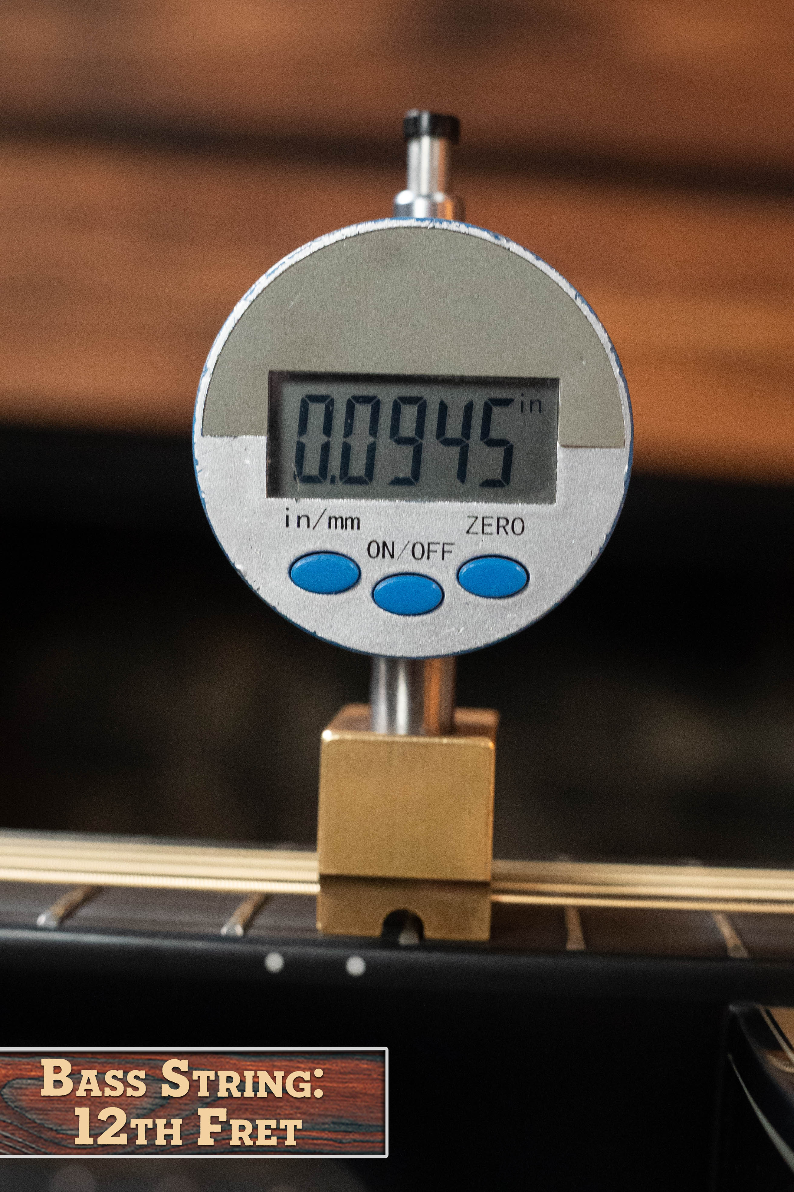 A digital gauge reads 0.0945 inches above a bass string at the 12th fret, similar to action checks on a Yamaha TAG3C-NT Sitka/Mahogany Natural Dreadnought Guitar w/the NEWEST TransAcoustic System #0558. Label: Bass String: 12th Fret.