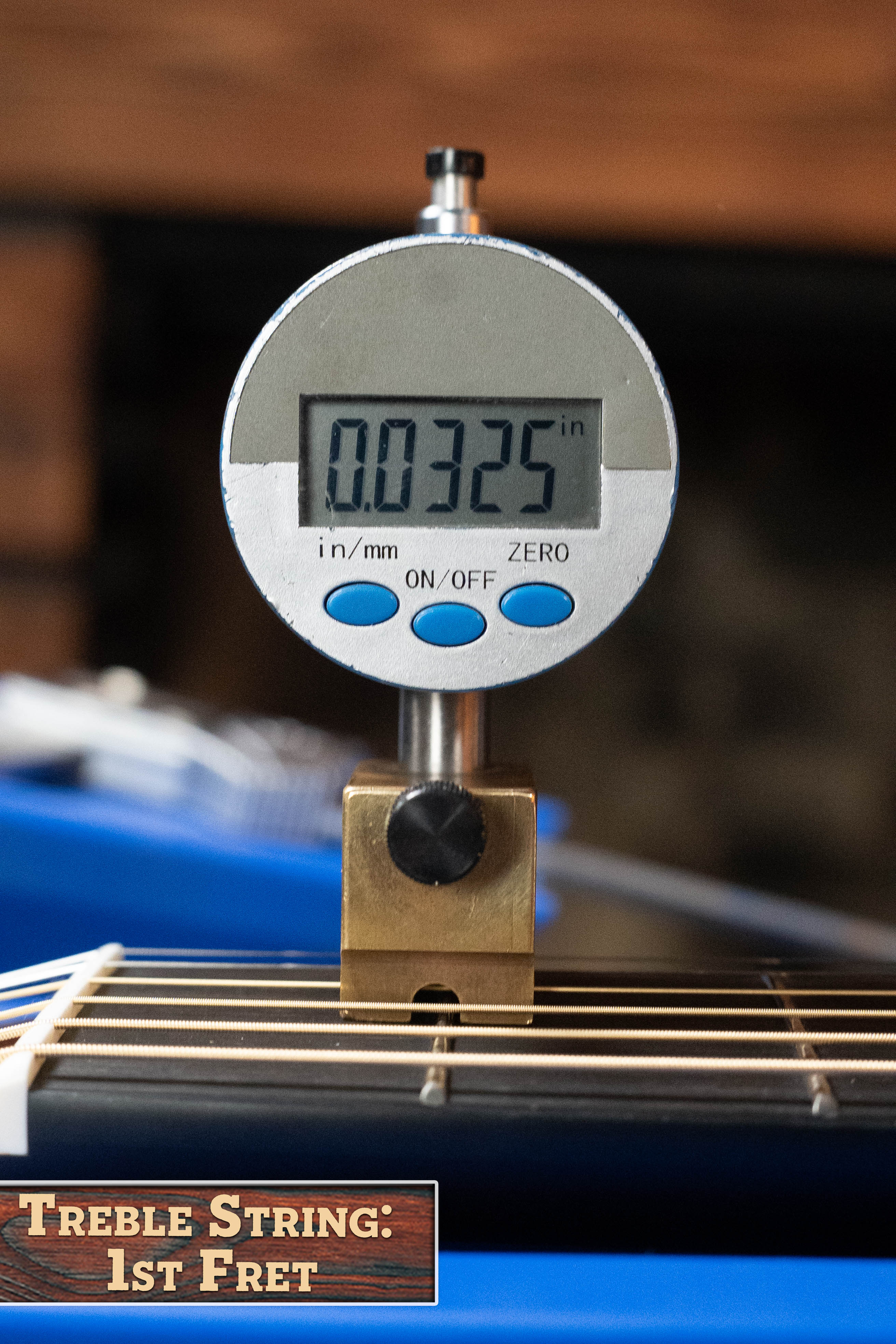 A digital gauge shows 0.0325 inches, measuring the treble string height at the 1st fret of a Yamaha TAG3C-NT Sitka/Mahogany Natural Dreadnought Guitar with the newest TransAcoustic System. Label: Treble String: 1st Fret.
