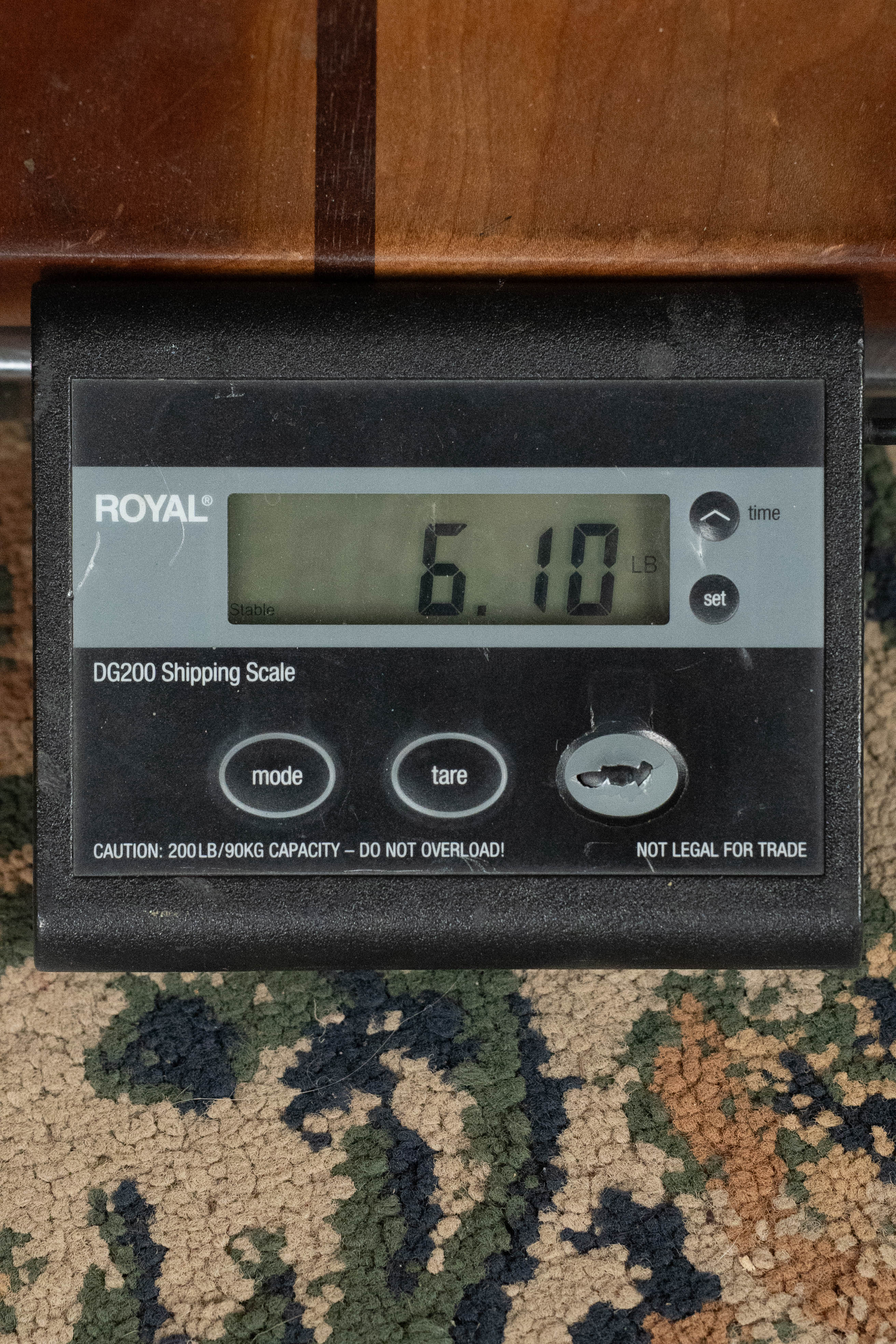 A Yamaha TAG3C-SDB guitar (Sitka/Mahogany, Sandburst, TransAcoustic System #0688) from Yamaha weighs 6.10 lbs on a black digital scale with gray buttons, making it easy to check shipping weight before sending.