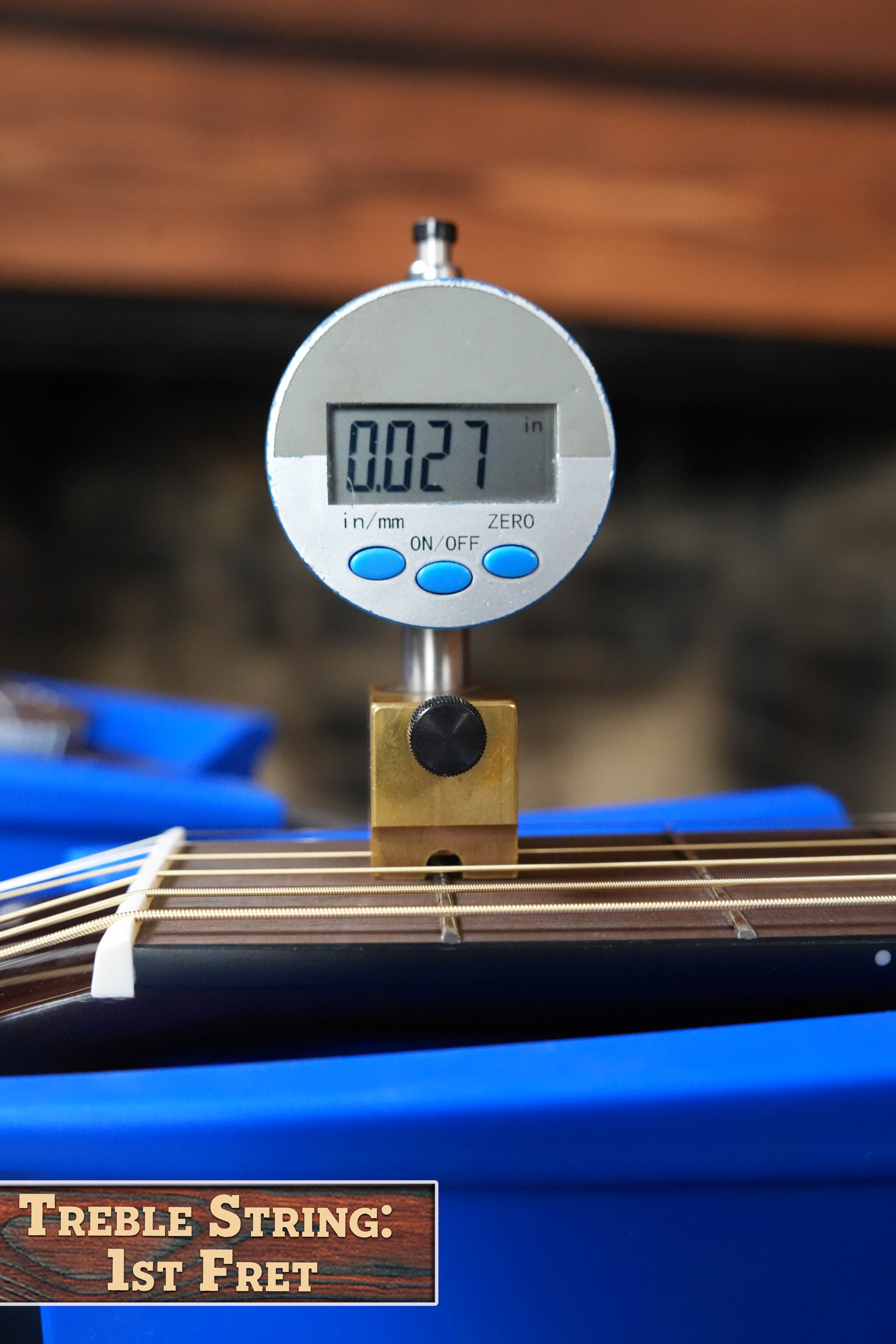 A digital gauge shows 0.027 inches when measuring the treble string height at the 1st fret of a Yamaha TAS1 C Sitka/Mahogany Sand Burst Transacoustic Concert Guitar w/Cutaway #0132. “Treble String: 1st Fret” appears bottom left.