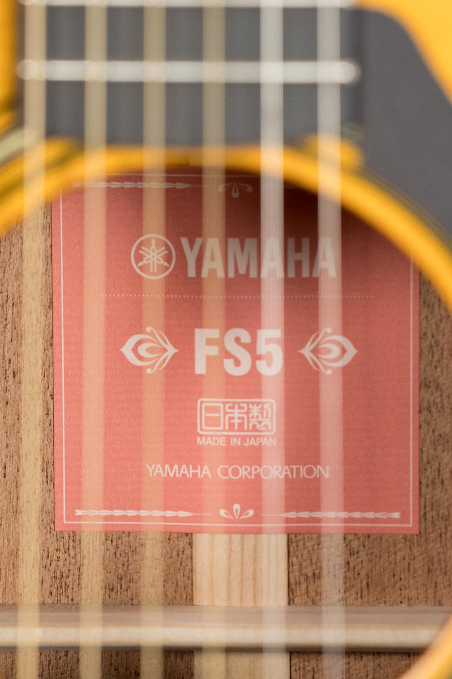 Glossy red-top Yamaha FS5 GL acoustic guitar with Sitka spruce top and mahogany body, close-up of soundhole label. - Yamaha FS5 GL New GLOSS Red Label Sitka/Mahogany Concert Acoustic Guitar #600A - Default Title