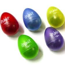 Five Dunlop Gel-Egg Shaker musical instruments by St. Louis Music (SLM), in red, blue, yellow, green, and purple, are arranged on a white surface. Each egg-shaped shaker features white text and comes in a random color.